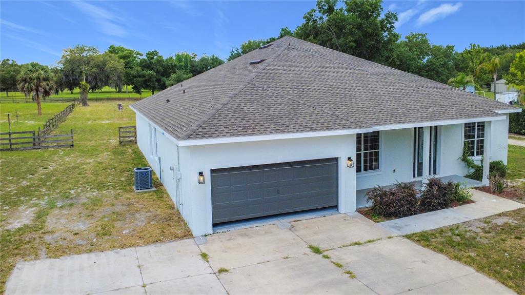 28549 Shirley Shores Road Tavares, FL 32778 - Photo 5 of 65 a front view of a house with a yard and garage
