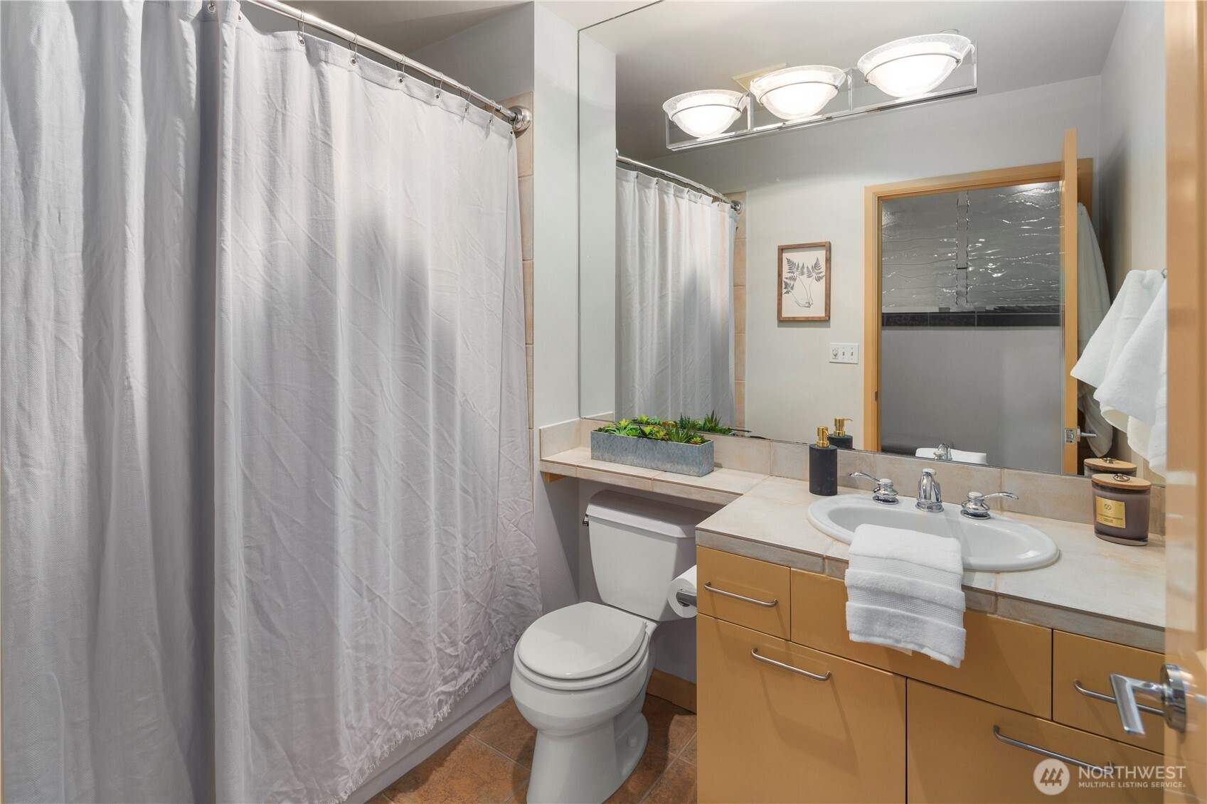 2319 1st Avenue, Unit 203 Seattle, WA 98121 - Photo 14 of 28 a bathroom with a sink vanity mirror and toilet