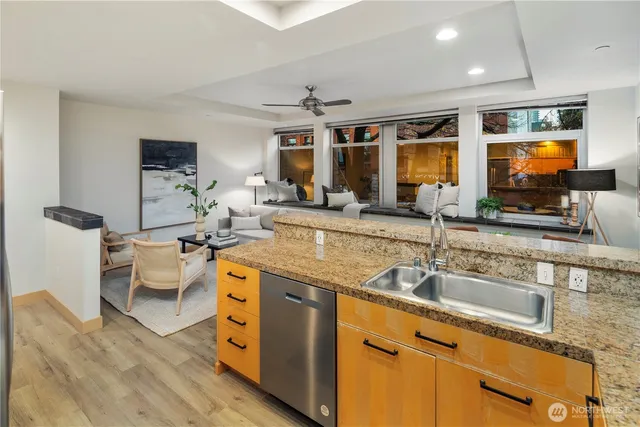 a kitchen with stainless steel appliances granite countertop a sink and a refrigerator