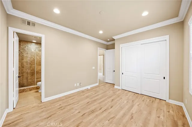 a living room with furniture a table and kitchen view
