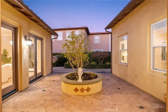 a spacious bedroom with a large bed and a chandelier