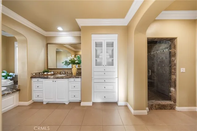 an aerial view of residential houses with outdoor space and ocean view