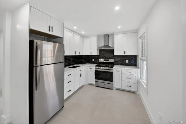 a kitchen with stainless steel appliances a refrigerator sink and stove