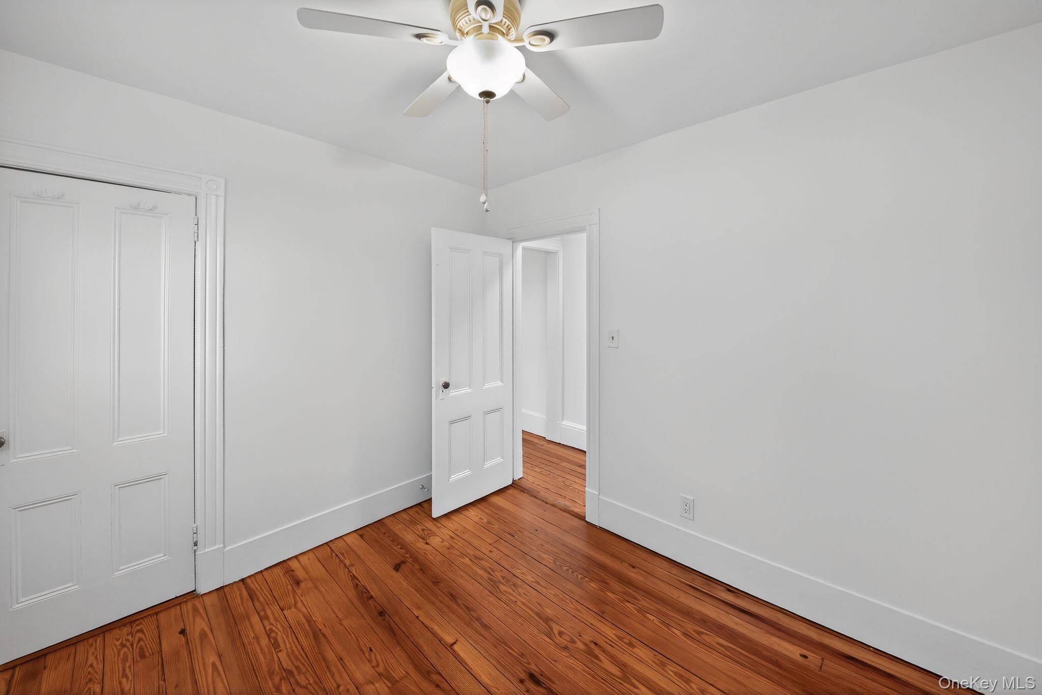 153 Franklin Avenue, Unit 2 Pearl River, NY 10965 - Photo 14 of 25 Unfurnished bedroom with a ceiling fan and hardwood / wood-style flooring