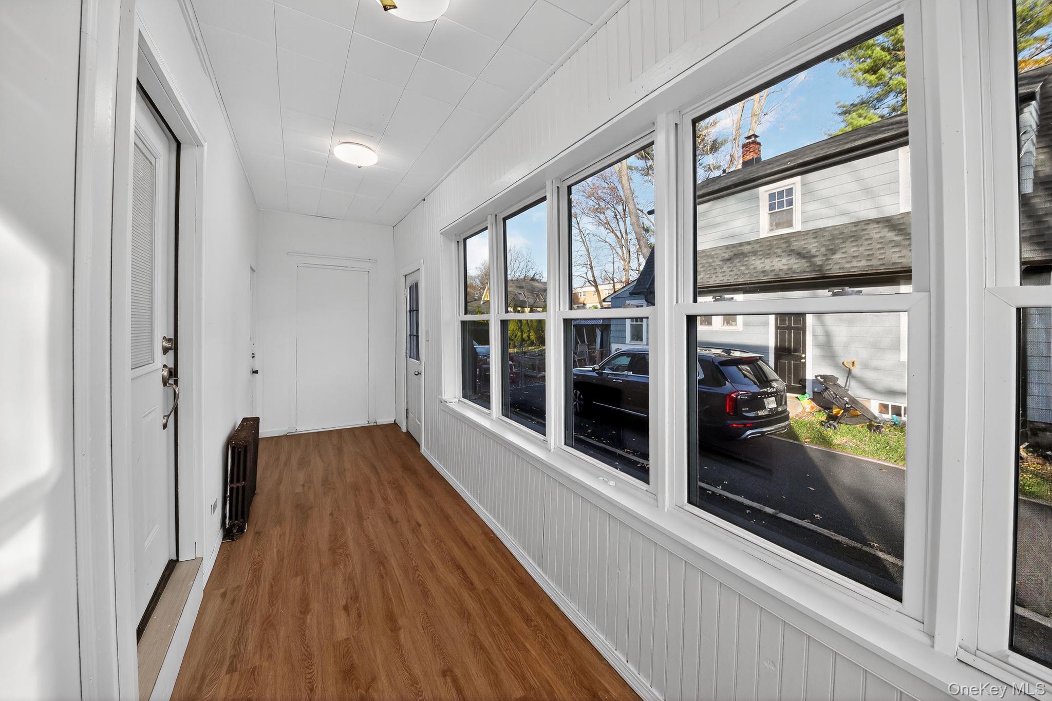 153 Franklin Avenue, Unit 2 Pearl River, NY 10965 - Photo 4 of 25 Sunroom featuring wood finished floors and radiator heating unit