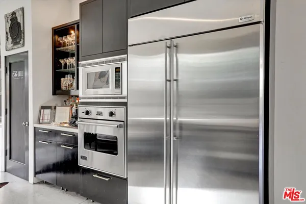 a kitchen with cabinets and stainless steel appliances