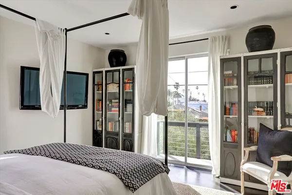 a bedroom with a large bed and a large window