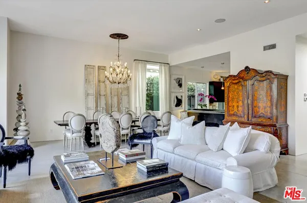 a living room with furniture chandelier and a chandelier