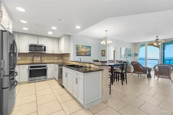 a kitchen with stainless steel appliances granite countertop a refrigerator and a sink