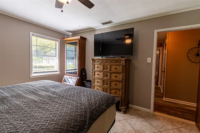 a bedroom with a bed and a flat screen tv