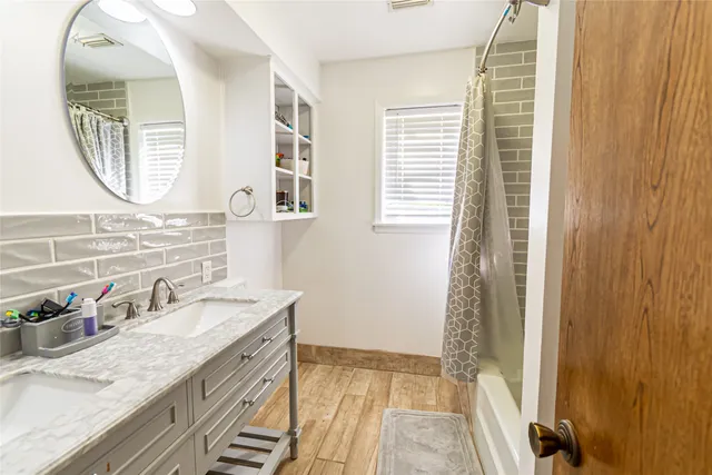 a bathroom with a granite countertop sink and a mirror