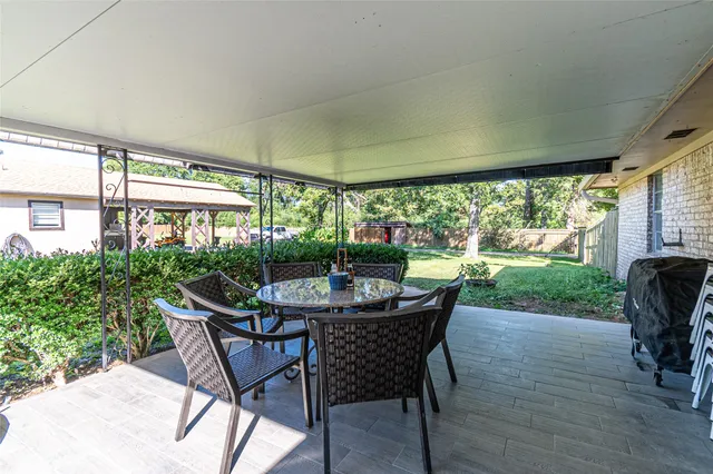a dining room with furniture and garden view