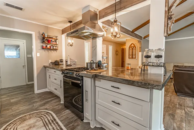 a kitchen with stainless steel appliances granite countertop a sink and cabinets