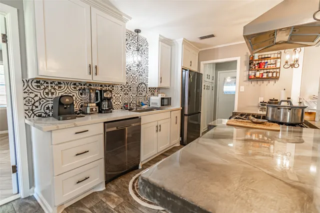 a kitchen with white cabinets and white appliances