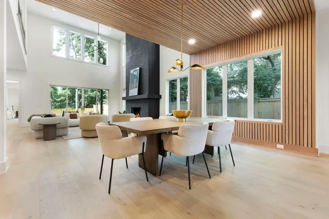 a dining room with furniture a rug and a large window