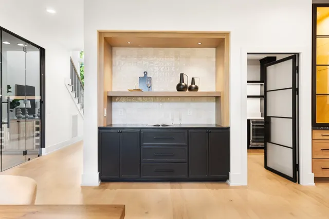a living room with a dresser and a wooden floor