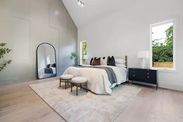 a spacious bedroom with a bed and a window