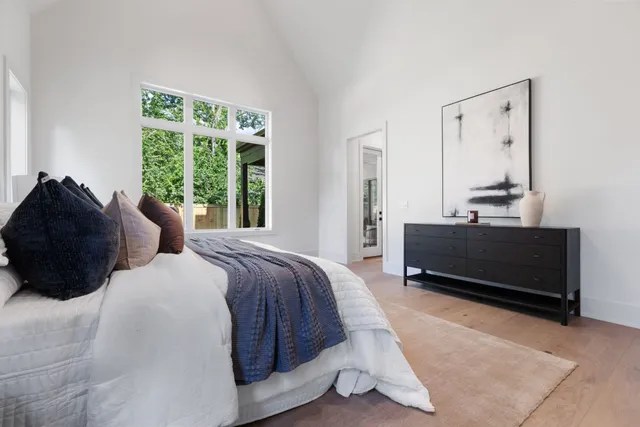 a bedroom with a bed a couch and a window