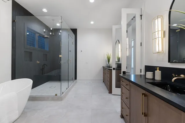 a bathroom with a double vanity sink toilet and shower
