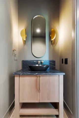 a bathroom with a sink a vanity and mirror