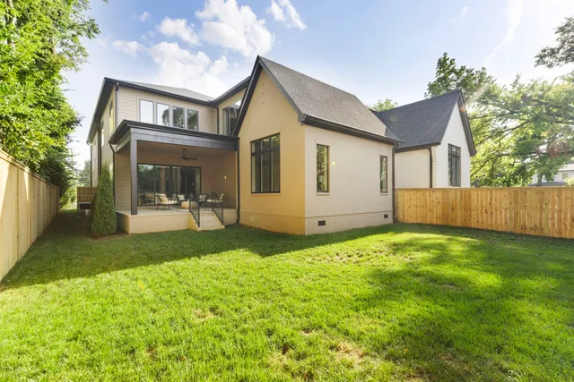 a backyard of a house with table and chairs