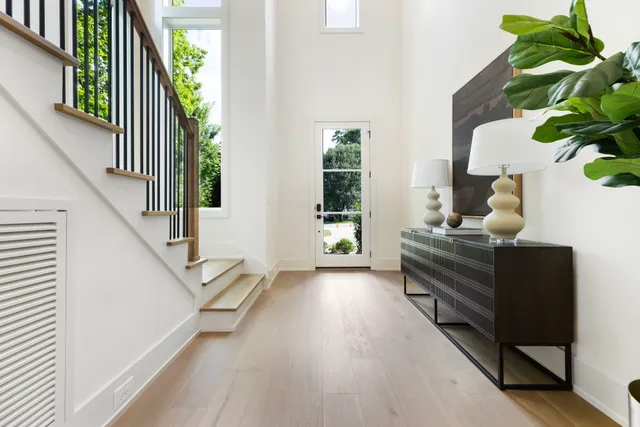 a living room with furniture and a potted plant