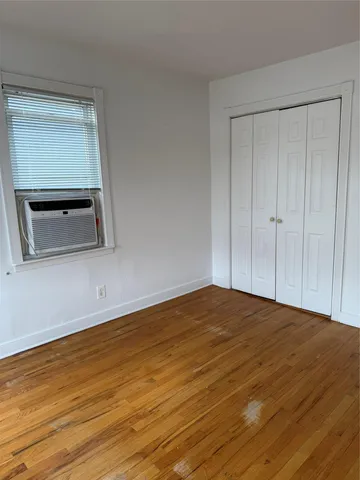 a view of a room with wooden floor and brick wall