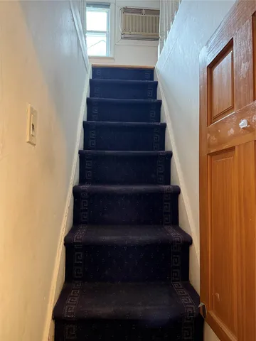 a view of a room with wooden floor and a window
