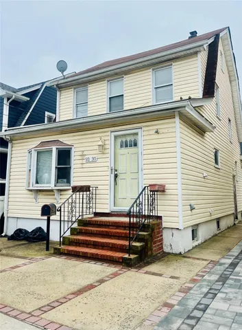 a view of a house with wooden fence