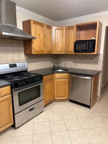 a kitchen with a stove sink and microwave
