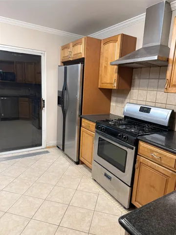 a kitchen with granite countertop a stove and a refrigerator
