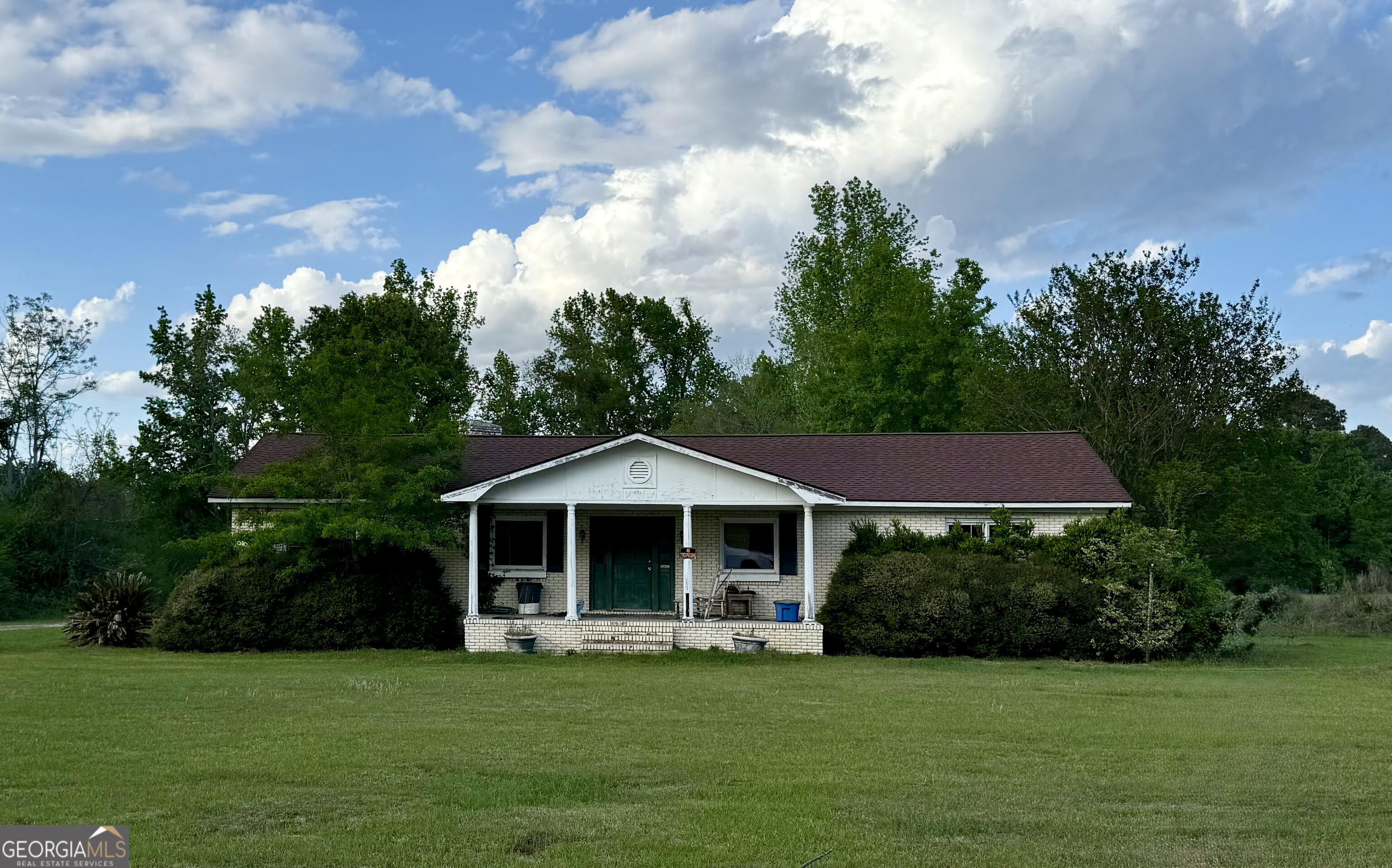 4136 West Old Savannah Road Millen, GA 30442 - Photo 1 of 1 a front view of a house with garden