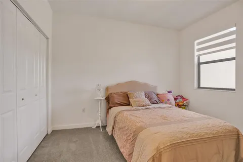 a bedroom with a bed and a night stand