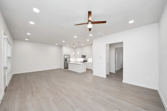 a view of a hallway with wooden floor