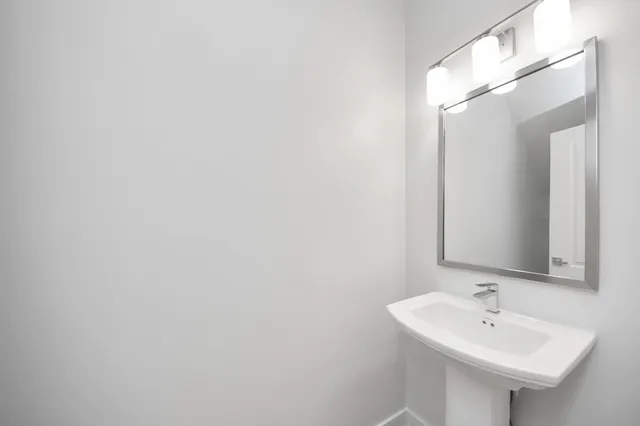 a kitchen with kitchen island a sink stainless steel appliances and white cabinets
