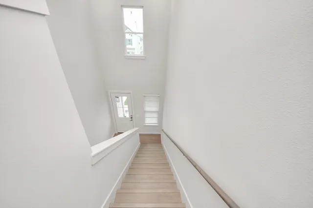 a large kitchen with stainless steel appliances kitchen island a large counter top and a refrigerator