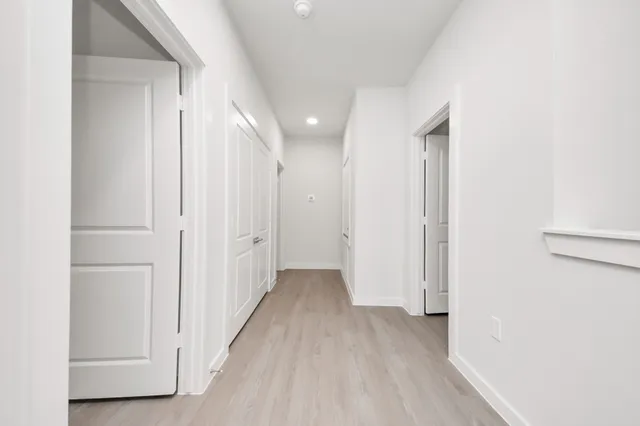 a kitchen with a sink and a stove top oven with wooden floor