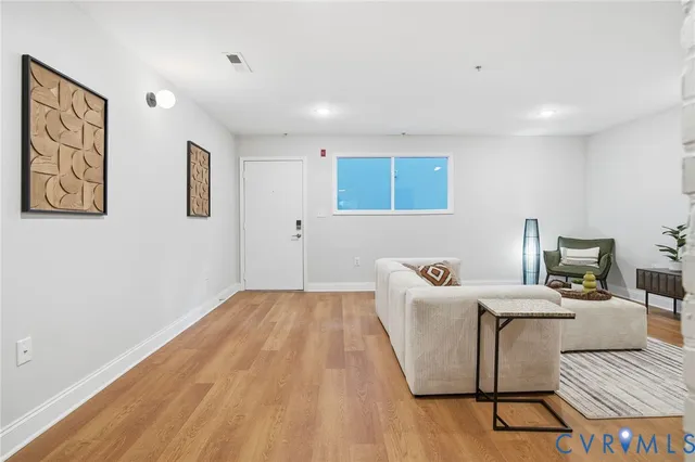 a spacious bedroom with a large bed and a chandelier
