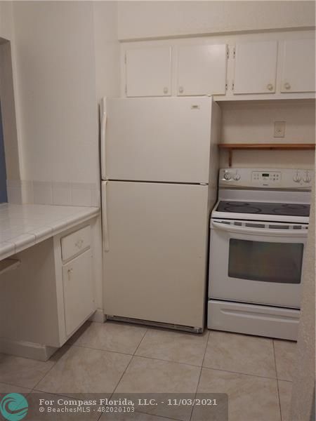 6501 Winfield Boulevard, Unit A11A Margate, FL 33063 - Photo 5 of 10 a view of a storage and utility room with washer and dryer