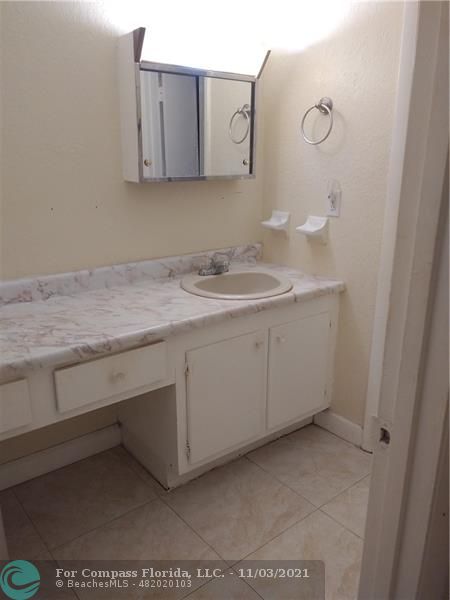 6501 Winfield Boulevard, Unit A11A Margate, FL 33063 - Photo 8 of 10 a bathroom with a sink and a mirror