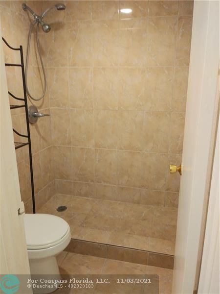 6501 Winfield Boulevard, Unit A11A Margate, FL 33063 - Photo 9 of 10 a bathroom with a toilet and a shower
