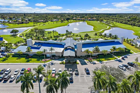 an aerial view of a house with swimming pool garden and lake view