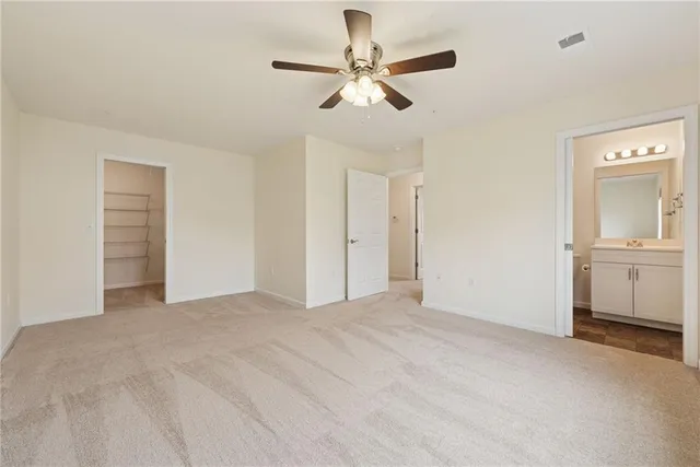 a view of a livingroom with a ceiling fan and window