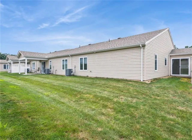 a view of a house with a backyard