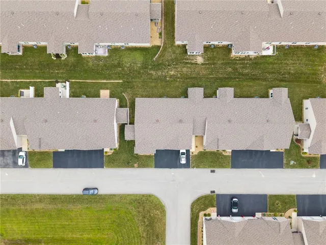 an aerial view of a house with a swimming pool