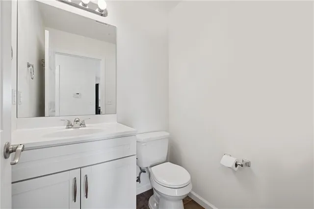 a bathroom with a sink a toilet and mirror