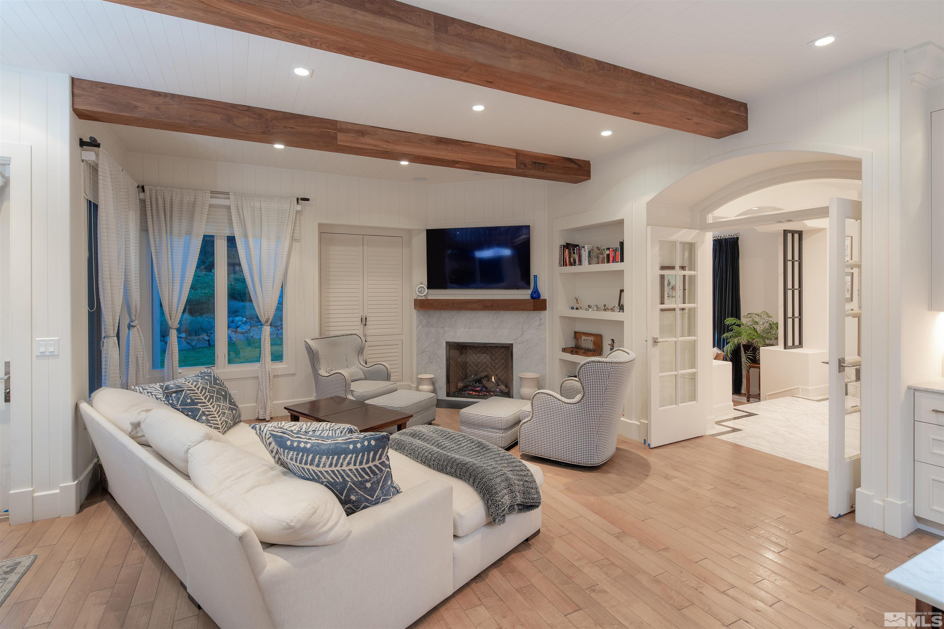 4305 Juniper Trail Reno, NV 89519 - Photo 21 of 30 a living room with furniture a fireplace and a flat screen tv