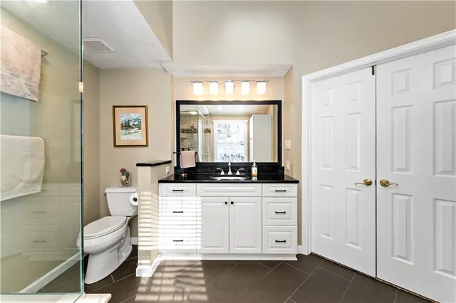 a bathroom with a toilet a sink and a mirror