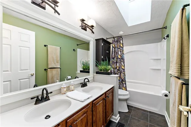 a bathroom with a double vanity sink mirror double and shower