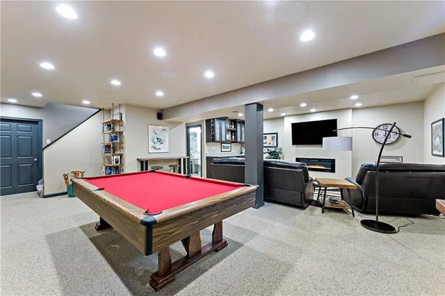 a room with furniture and pool table